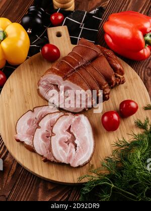 ham sliced on a background with vegetables and spices Stock Photo