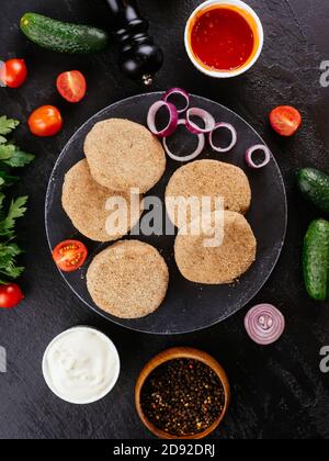 fresh pork cutlets with vegetables on the background Stock Photo