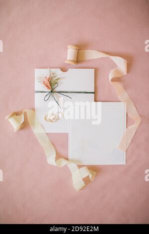 wedding invitation on pink backdrop. Stock Photo