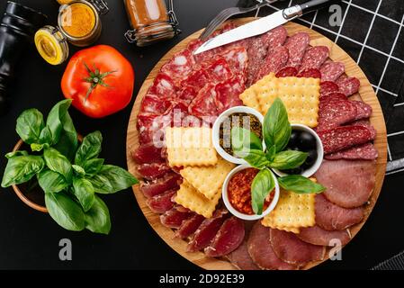 various meats and ham sliced on a wooden plate Stock Photo