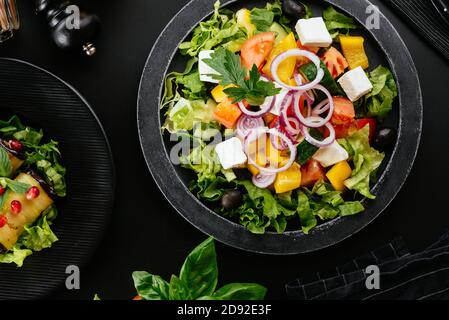 Georgian vegetable salad with different vegetables and spices on the background Stock Photo