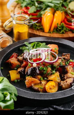 Georgian salad with meat on a black background Stock Photo