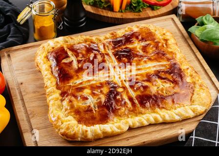 Georgian cheese tortilla, vegetables on a black background Stock Photo