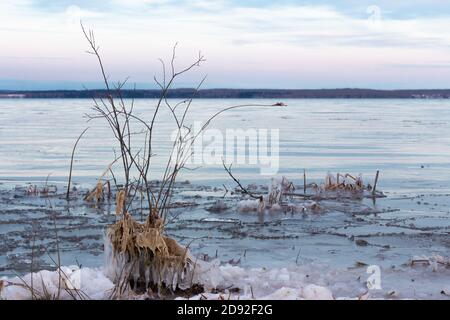 Lake beginning to freeze over in winter, prairie lake, Saskatchewan Canada Stock Photo