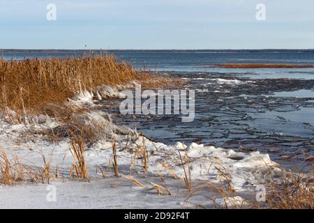 Lake beginning to freeze over in winter, prairie lake, Saskatchewan Canada Stock Photo