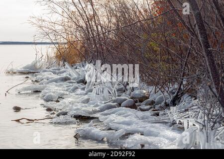 Lake beginning to freeze over in winter, prairie lake, Saskatchewan Canada Stock Photo