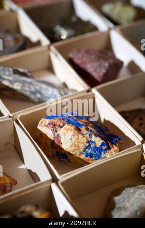 Collection of minerals in cardboard boxes. Stock Photo