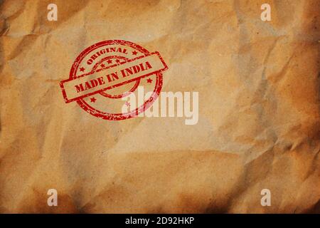 Made in INDIA stamp printed on crumpled sheet of burnt paper. Indian product, parcel, package, production logistics concept. Background with copyspace Stock Photo