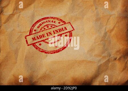 Made in INDIA stamp printed on crumpled sheet of burnt paper. Indian product, parcel, package, production logistics concept. Background with copyspace Stock Photo