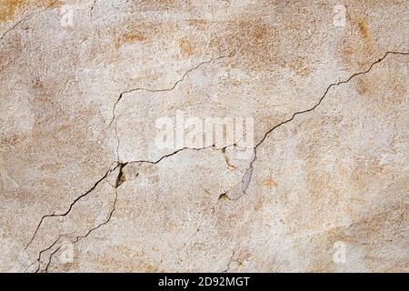 Old cracked concrete wall, weathered building background. Stock Photo
