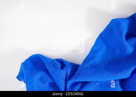 Crumpled blue fabric on white background. Copy space for text Stock Photo