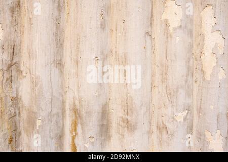 Old dirty wall with cracked beige paint. Empty building texture background Stock Photo