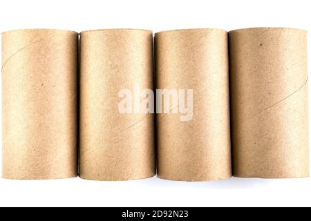 Top view of four cardboard paper tubes in the row on white background. Close-up of empty toilet rolls Stock Photo