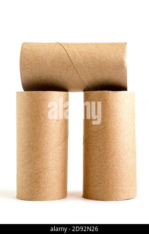 Composition from three cardboard paper tubes on white background. Close-up of empty toilet rolls Stock Photo