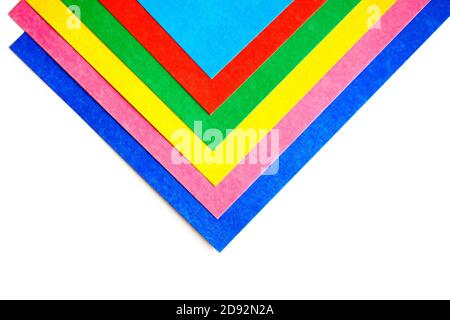 Geometric pattern from colorful sheets of cardboard on a white background. Top view Stock Photo