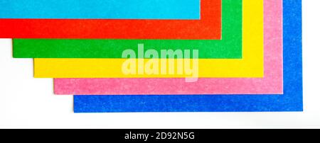 Geometric pattern from colorful sheets of cardboard on a white background. Concept for banner page wallpaper design Stock Photo
