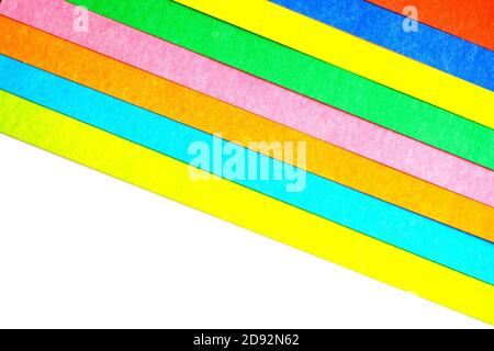 multicolored stripes at an angle from paperboard on white background, top view Stock Photo