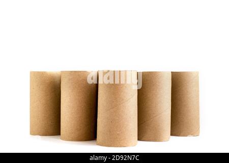 Five cardboard paper tubes on white background. Close-up of empty toilet rolls Stock Photo