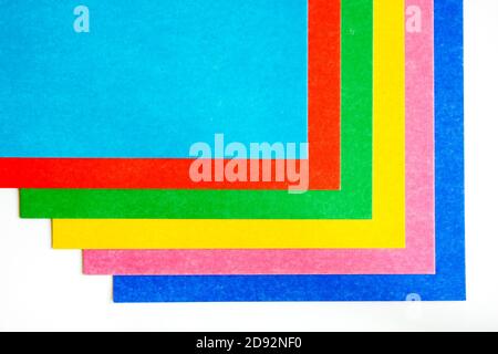 graphic pattern from colorful sheets of cardboard on a white background. Copy space, top view Stock Photo
