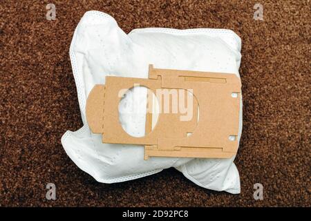 close-up of used vacuum cleaner bag on brown mat background, top view Stock Photo