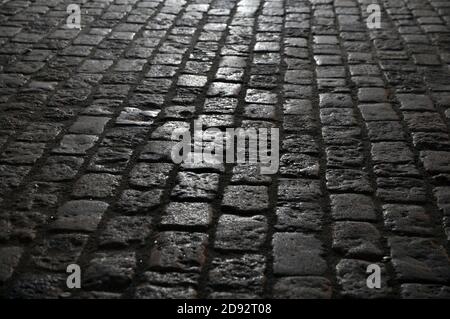 Granite paving stones on the pavement at night. Stock Photo