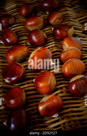 A close up of Chestnuts on a wicker basket. Stock Photo