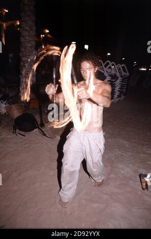 Fire poi juggling at the sunset celebrations outside Cafe Mambo in San Antonio Ibiza Balearic Islands Spain Stock Photo