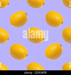 Seamless pattern with yellow lemons on purple background Stock Photo