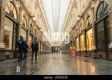 Brussels, Belgium. 2nd Nov, 2020. Police patrol in the Royal Gallery of Saint Hubert in Brussels, Belgium, Nov. 2, 2020. Starting from Nov. 2, Belgium moved to stricter lockdown, with rules valid throughout the country to fight against COVID-19. According to the rules, all non-essential businesses have to close. Food stores and supermarkets remain open. Credit: Zheng Huansong/Xinhua/Alamy Live News Stock Photo