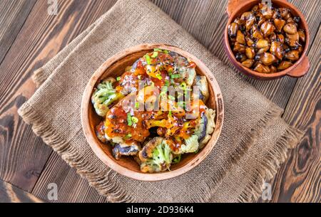 Bowl of Asian fried cauliflower with sweet chili sauce Stock Photo