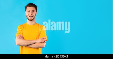 Smiling confident man posing on blue background Stock Photo