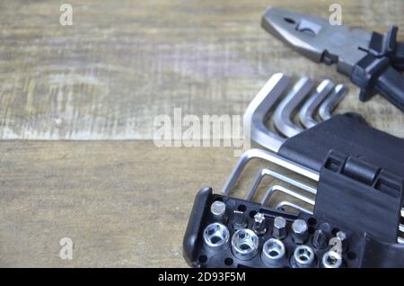 Top view of Working tools,wrench,socket wrench,hammer,screwdriver,plier,electric drill,tape measure,machinist square on wooden board. flat lay design. Stock Photo