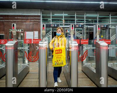 Moscow. Russia. October 29, 2020. Passengers pass through automatic turnstiles at the Moscow metro station. On the faces of people, protective masks Stock Photo