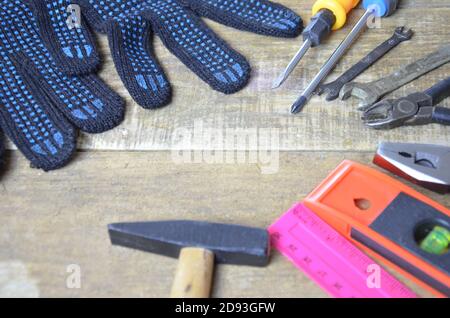 Top view of Working tools,wrench,socket wrench,hammer,screwdriver,plier,electric drill,tape measure,machinist square on wooden board. flat lay design. Stock Photo