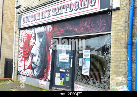 Cambridge UK, England , 02-11-2020, Entrance to a Tattoo artist studio with  art work to one window Stock Photo - Alamy