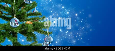 a Christmas tree adorned with christmas bauble made from glass contain pictures Stock Photo