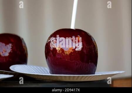 Close up of caramelized dark red apples on a stick Stock Photo
