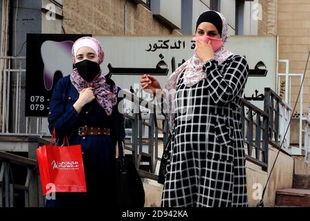 Amman, Jordan. 2nd Nov, 2020. People wearing face masks are seen on a street in Amman, capital of Jordan, on Nov. 2, 2020. Jordan on Monday recorded 5,877 new coronavirus cases, the highest daily spike in the country so far, raising the tally to 81,743. Credit: Mohammad Abu Ghosh/Xinhua/Alamy Live News Stock Photo