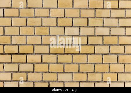 Surface of a yellow brick wall. Stock Photo