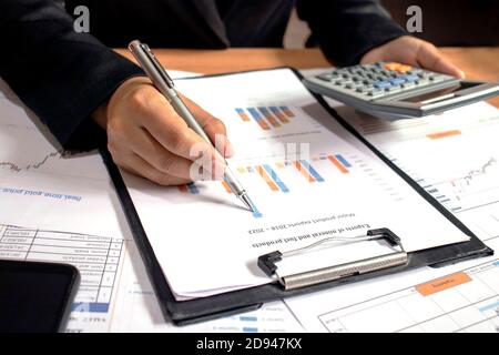 Businessmen are reviewing reports, financial documents for financial data analysis, work ideas and market data. Stock Photo