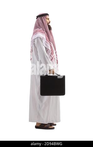 Full length profile shot of an arab businessman in a thobe standing and smiling isolated on white background Stock Photo