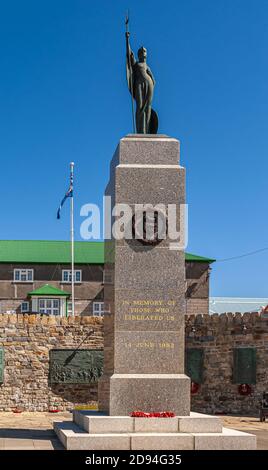 Stanley, Falkland Islands, UK - December 15, 2008: Gray marble statue with bronze statue on top as memorial of liberation in 1982 set in its small ref Stock Photo