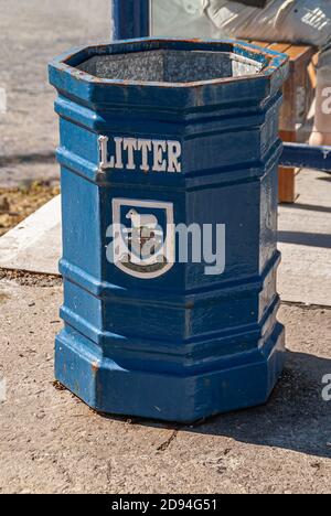 Stanley, Falkland Islands, UK - December 15, 2008: Closeup of blue public garbage, litter, can with local coat of arms. Stock Photo
