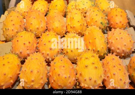 fresh cucumis metuliferus on the stall for sale under bright light Stock Photo