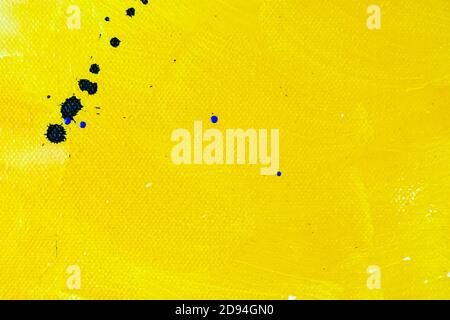 Abstract yellow and neutral tone painted background with blue paint drops. Stock Photo