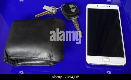 Smartphone and car keys on blue background Stock Photo