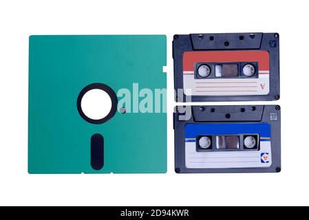 Close up view of the floppy disk and old audiotape cassette isolated over white background Stock Photo