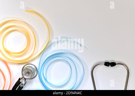 Butterfly made of satin ribbons with multi colored wings. And a stethoscope at the bottom right. Stock Photo