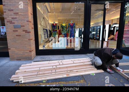 New York City, USA. 02nd Nov, 2020. On the eve of the U.S. Presidential Elections, workers are seen preparing to board up luxury retail store Moschino in Soho, in case of election unrest, New York, NY, November 2, 2020. Retailers across the country are boarding up their stores to stem any damages to their stores in case of election-related protest or unrest. (Anthony Behar/Sipa USA) Credit: Sipa USA/Alamy Live News Stock Photo