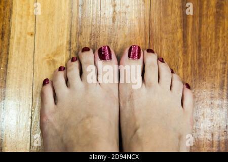 women feet after pedicure with red nails background Stock Photo